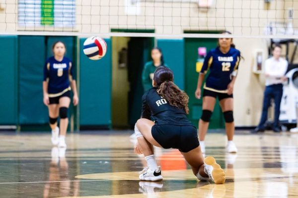The ILS Girls Volleyball middle player anticipating the ball, scores a point for the team. 