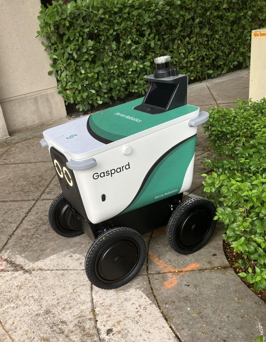 A Serve Robotics delivery robot named Gaspard rolls through Coral Gables, one of the Miami neighborhoods where food robots have become a common sight.