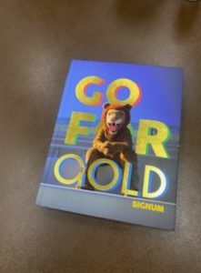 The new ILS 2024-2025 yearbook features its distinctive title  and bold gold accents.