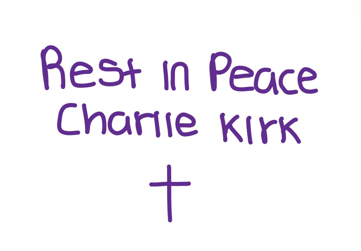 Purple writing displaying rest in peace Charlie Kirk with a cross below