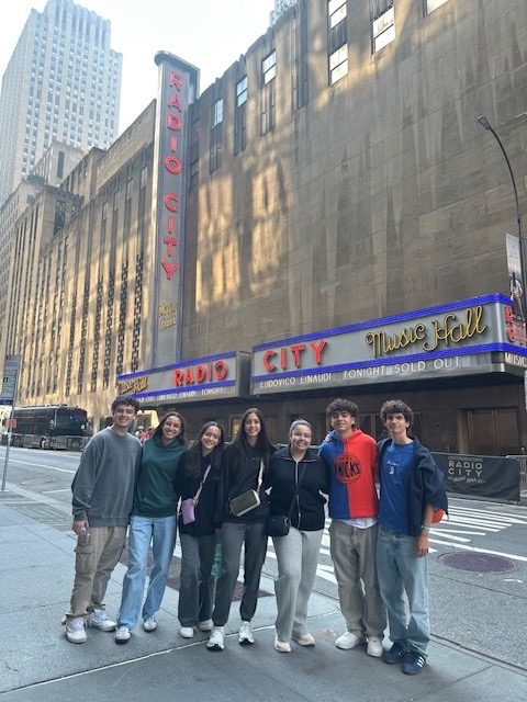 Students together in a photo outside of Radio City in New York City