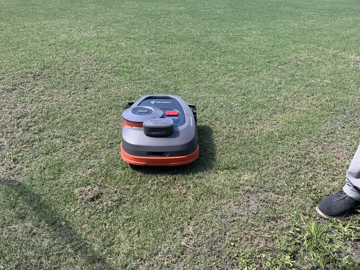 The famous robot mower cleans up the field behind the 600 building. 