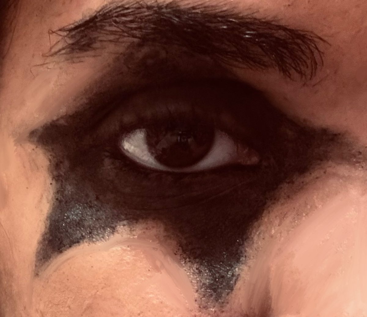 The photo shows an Ace  Frehley inspired look based on his iconic star eye makeup.