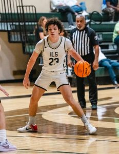 Focused and composed, a Royals' basketball player controls his pace on the court.