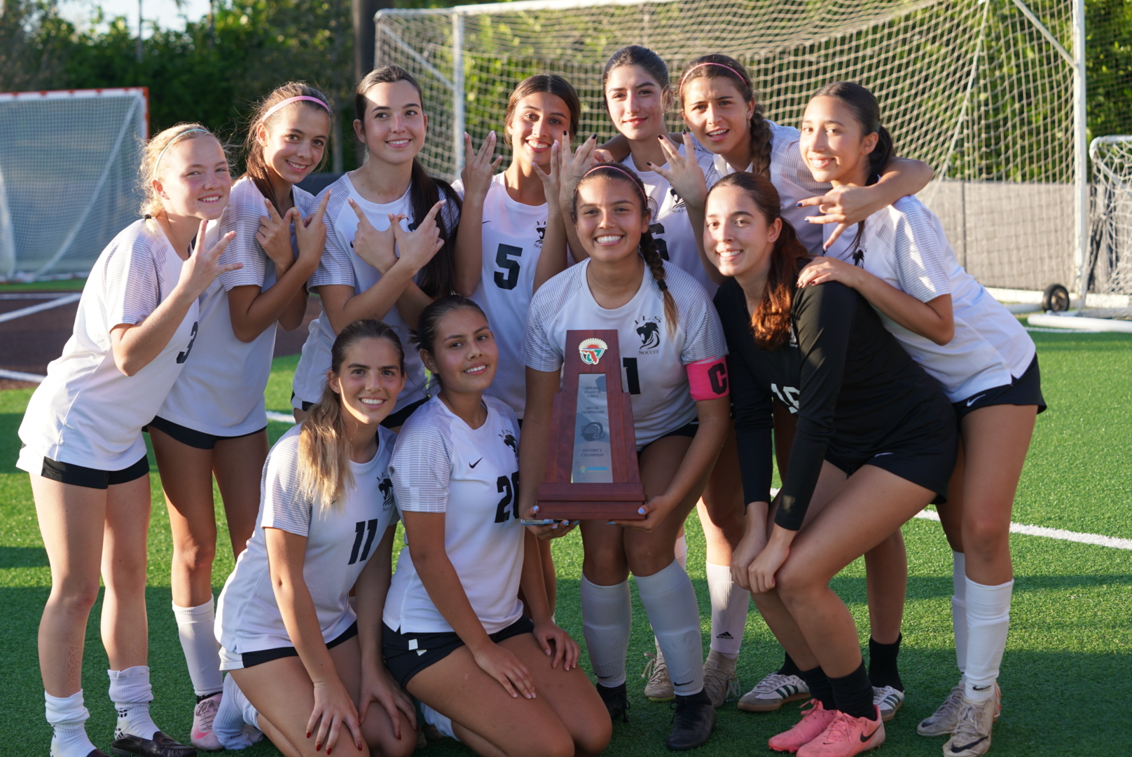 The ILS Girls Soccer team celebrates together after their 3–1 victory to win the district championship.