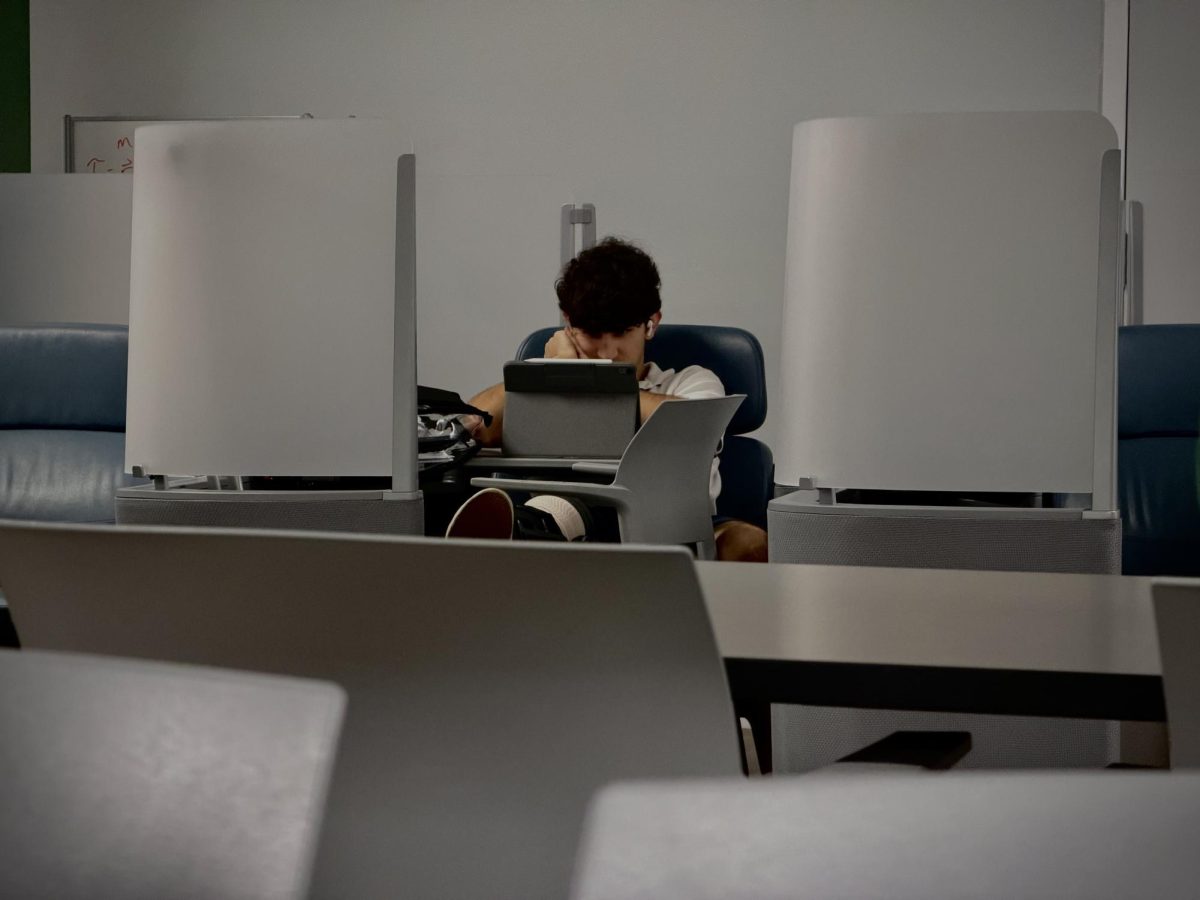 Senior Rafael Murta sits in his SLC “pod”, designed for injured students to take their virtual classes. Rafa, representing many other injured students, is a star soccer player for the Royals, but recently tore his ACL in a game. Steadily on the road to recovery, Rafa focuses in on his class, trying not to fall behind in a difficult situation, like many around him.
