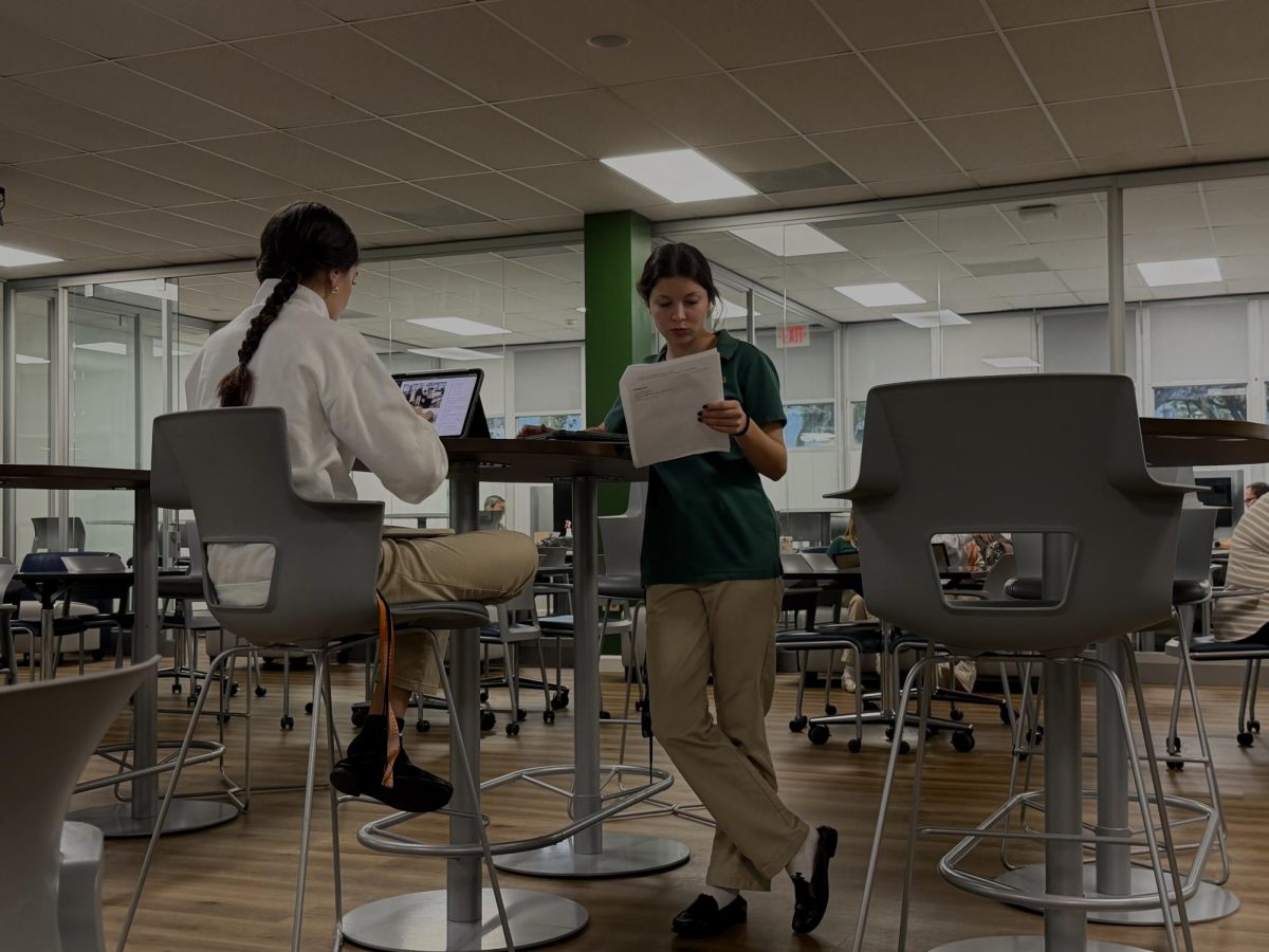 Sophomores Violeta Fausciana (left) and Mistra Toffalo Akil (right) work together on a journalism project. They use the high tables in the student learning center, quietly but effectively collaborating, and using the space to brainstorm. 