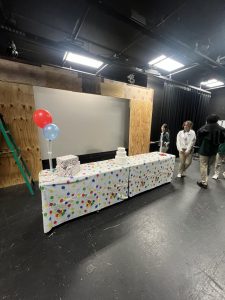 Freshman Drama Club members stand around the set they will be acting in later.