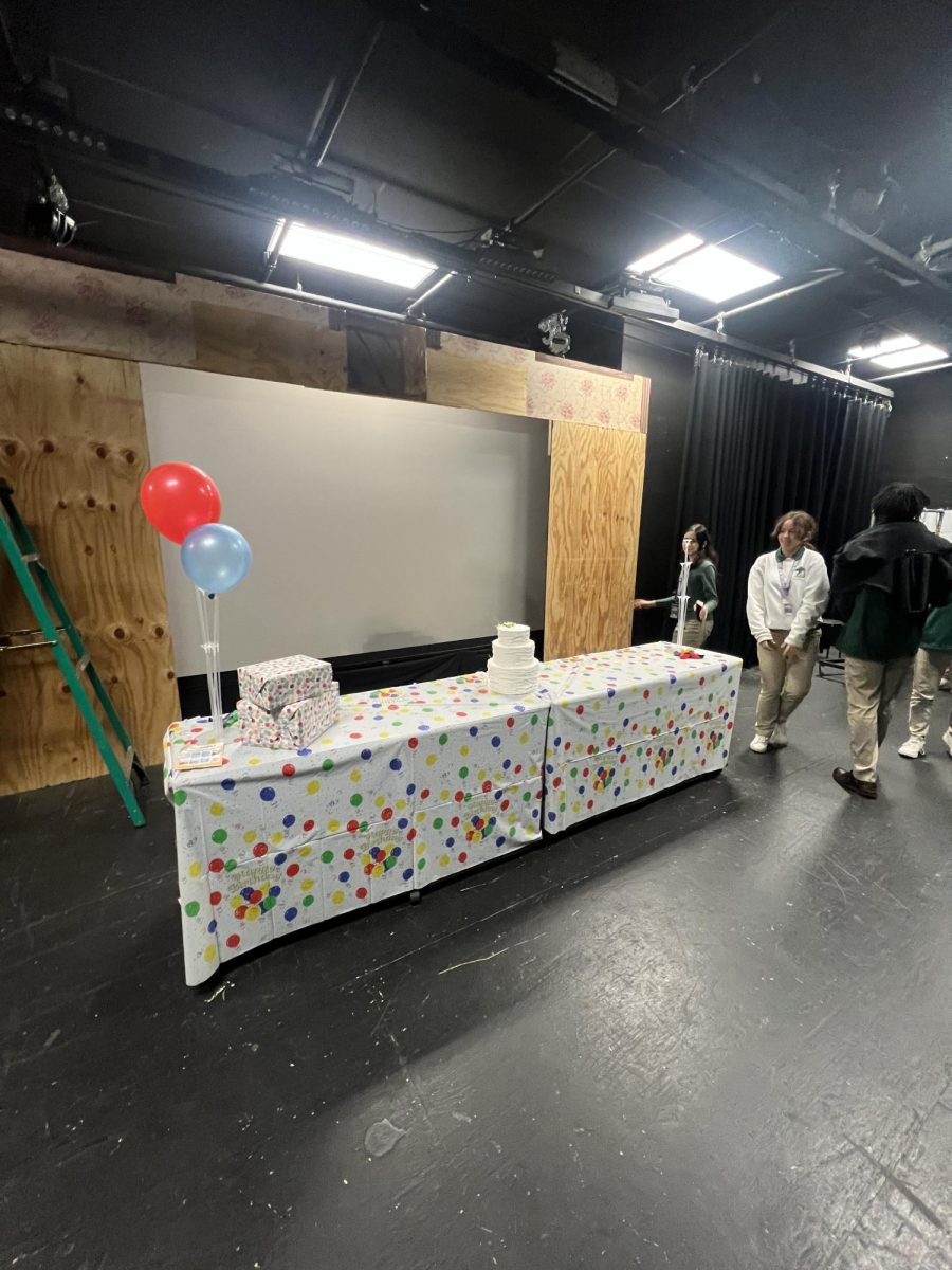 Freshman Drama Club members stand around the set they will be acting in later.