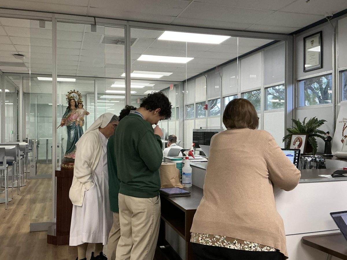 Sister is helping student Victtorio Buttice in the SLC demonstrating community at work