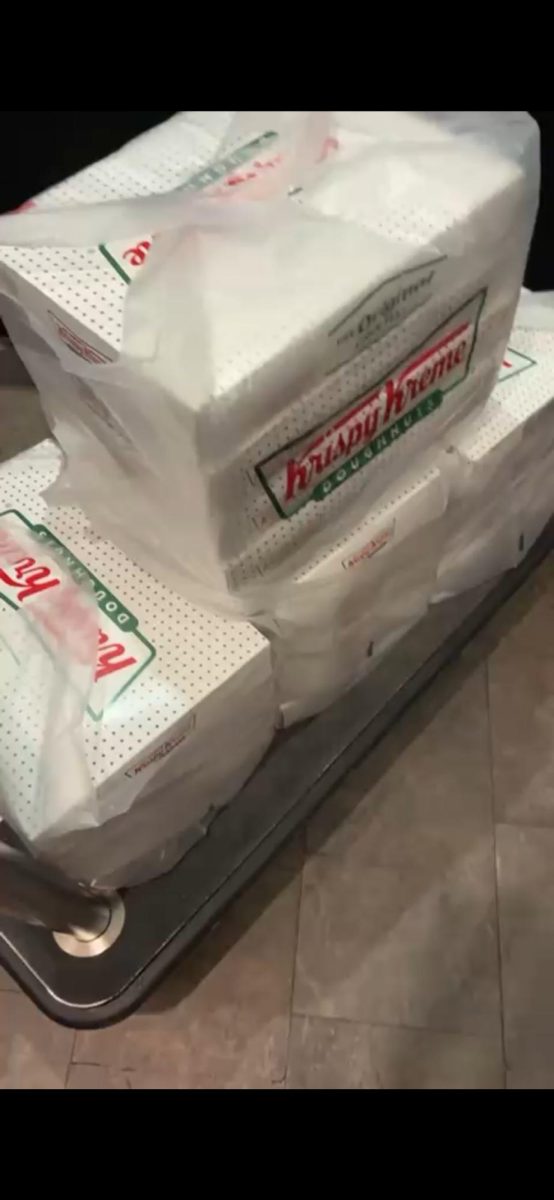 Club founder Dante Caicedo is brought the doughnuts for today's fundraiser.