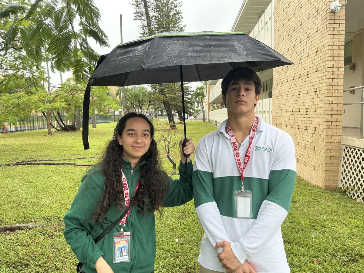 Two Seniors, Clara Custodia and George Mavris, aim to stay dry during a recent on campus down-pour.