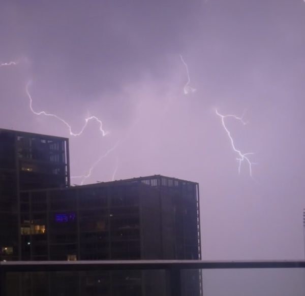 A purple sky serves as the backdrop for lightning bolts illuminating another Miami evening.