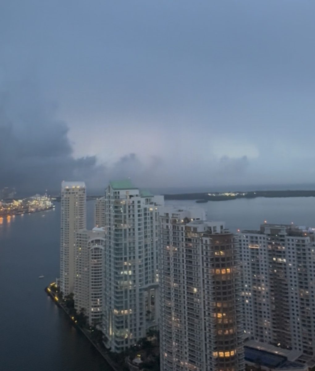 A daytime storm rolling in with lightning lighting up the clouds.