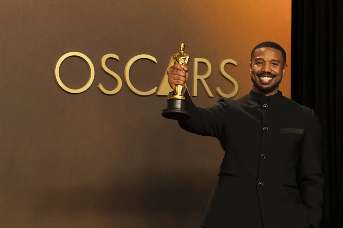 Michael B. Jordan who starred in the popular film Sinners holds aloft his 2026 Oscar for Best Actor