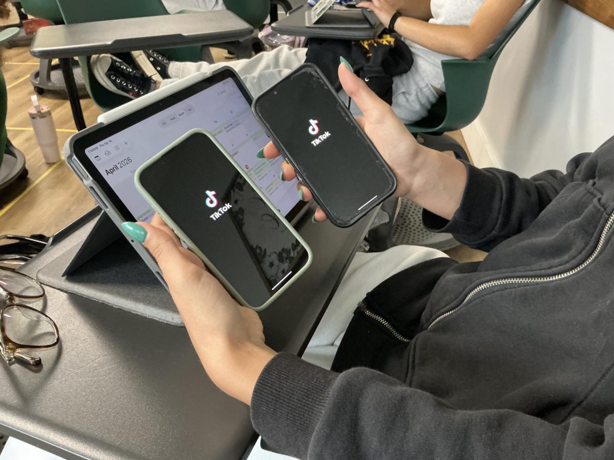 A student is seen opening popular social media platform TikTok to scroll through creator videos.