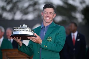Rory McIlroy, the final winner of the Masters tournament, beams with pride as he holds aloft the trophy.