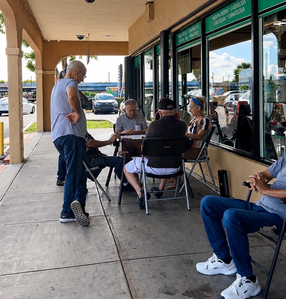 A common site across Miami in parks, or outside restaurants such as this one, is a gathering a people playing dominos.