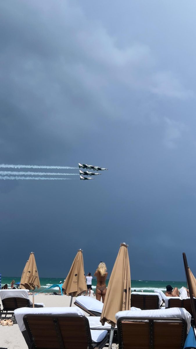 Advanced aircraft military planes fly overhead as beach goers gather to enjoy the annual Air and Sea Show on South Beach.