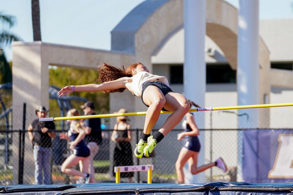Senior Abrielle Meyer completes an acrobatic high jump for a meet at Belen Jesuit for which she won first place. 