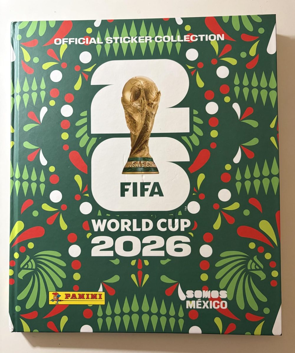 The colorful FIFA 2026 Panini sticker album features the iconic World Cup trophy.