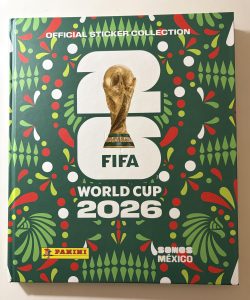 The colorful FIFA 2026 Panini sticker album features the iconic World Cup trophy.