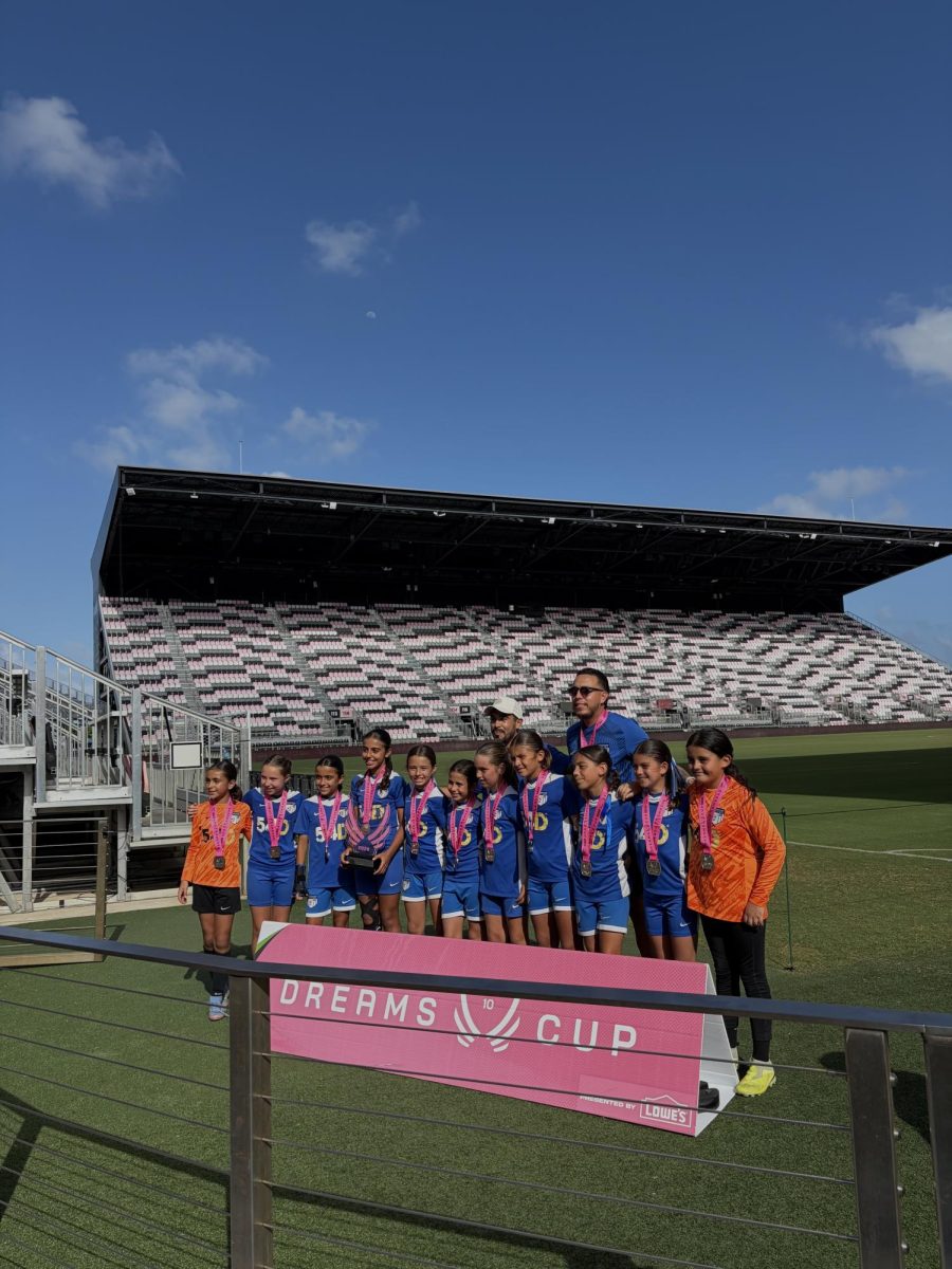 The U11 Girls from the Key Biscayne Soccer Club gather to receive an award after successfully competing at the tournament final.
