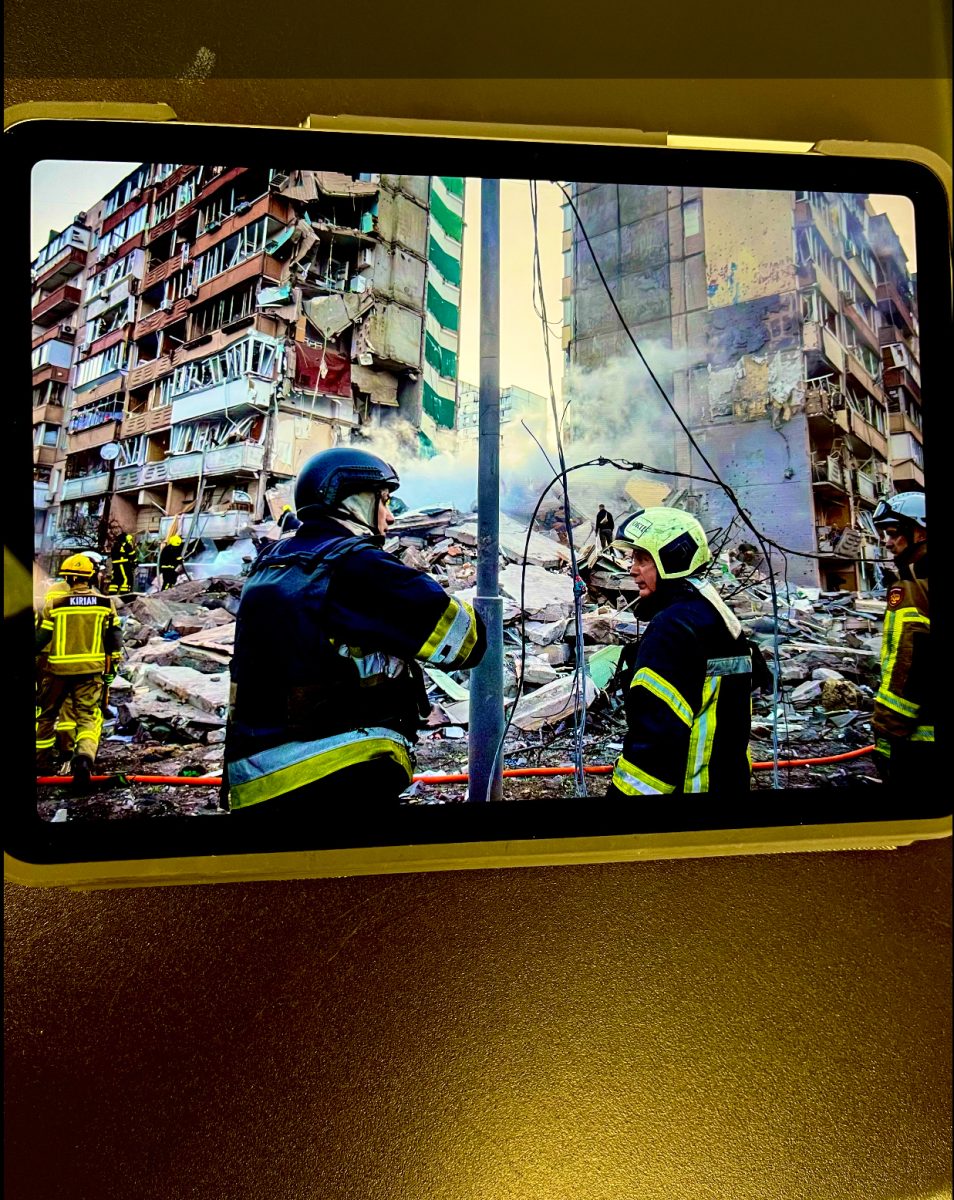 A students watches an online image of the ongoing war in Ukraine.