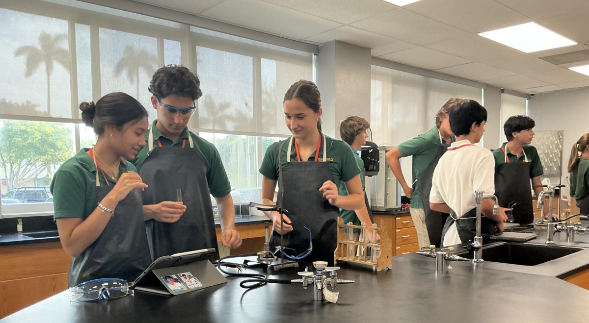 Sophomores Sarah Panesso, Marc De La Cruz, and Martina Sanchez Welsh prepare for a chemistry lab in Mr. Jorge Pacheco’s E Block in room 405.