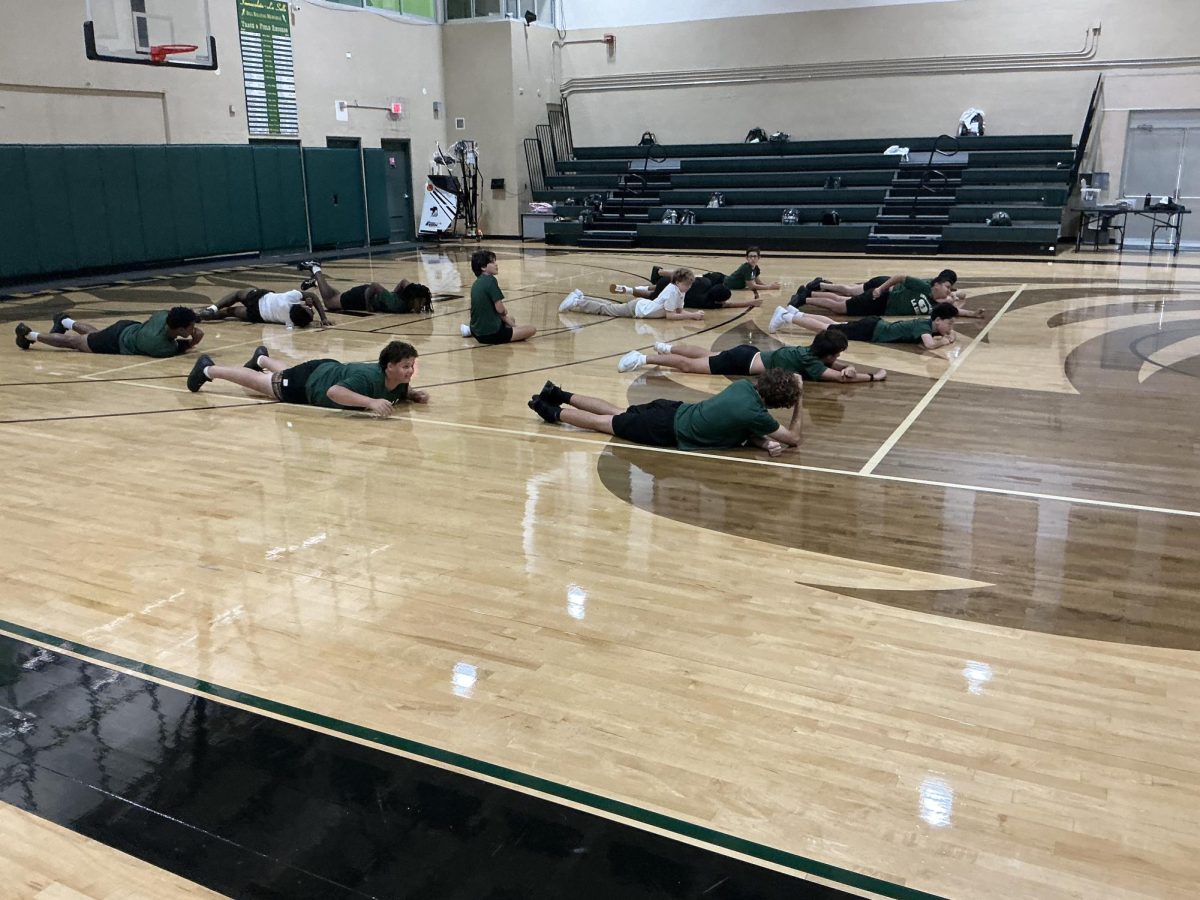 These freshmen are stretching in gym class in the Gymnasium