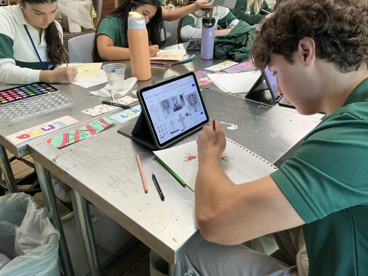 Junior transfer and first year art student, Mark Gutman, navigates the internet to gather ideas to design a latin cross using a classic coloring technique. 
