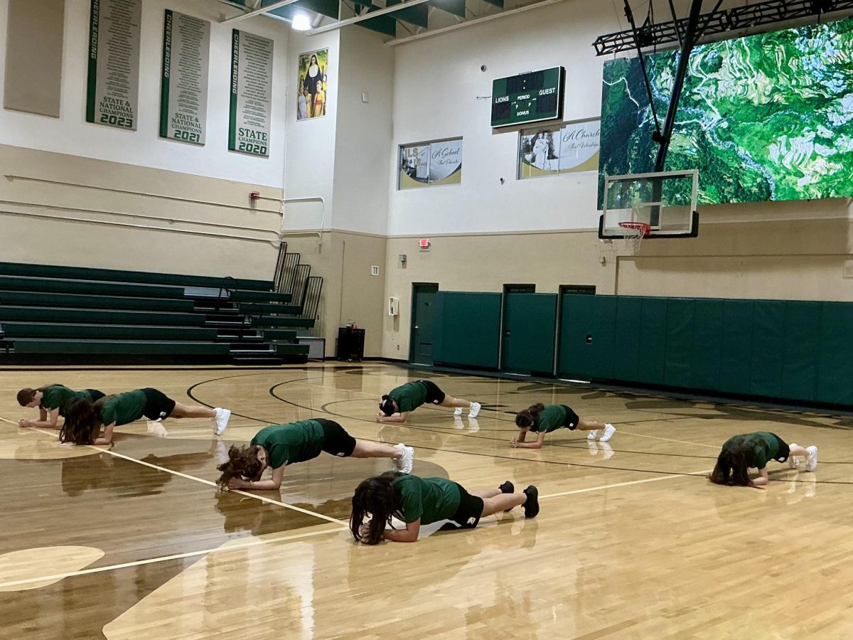 Freshman girls in A block PE class doing planks. 