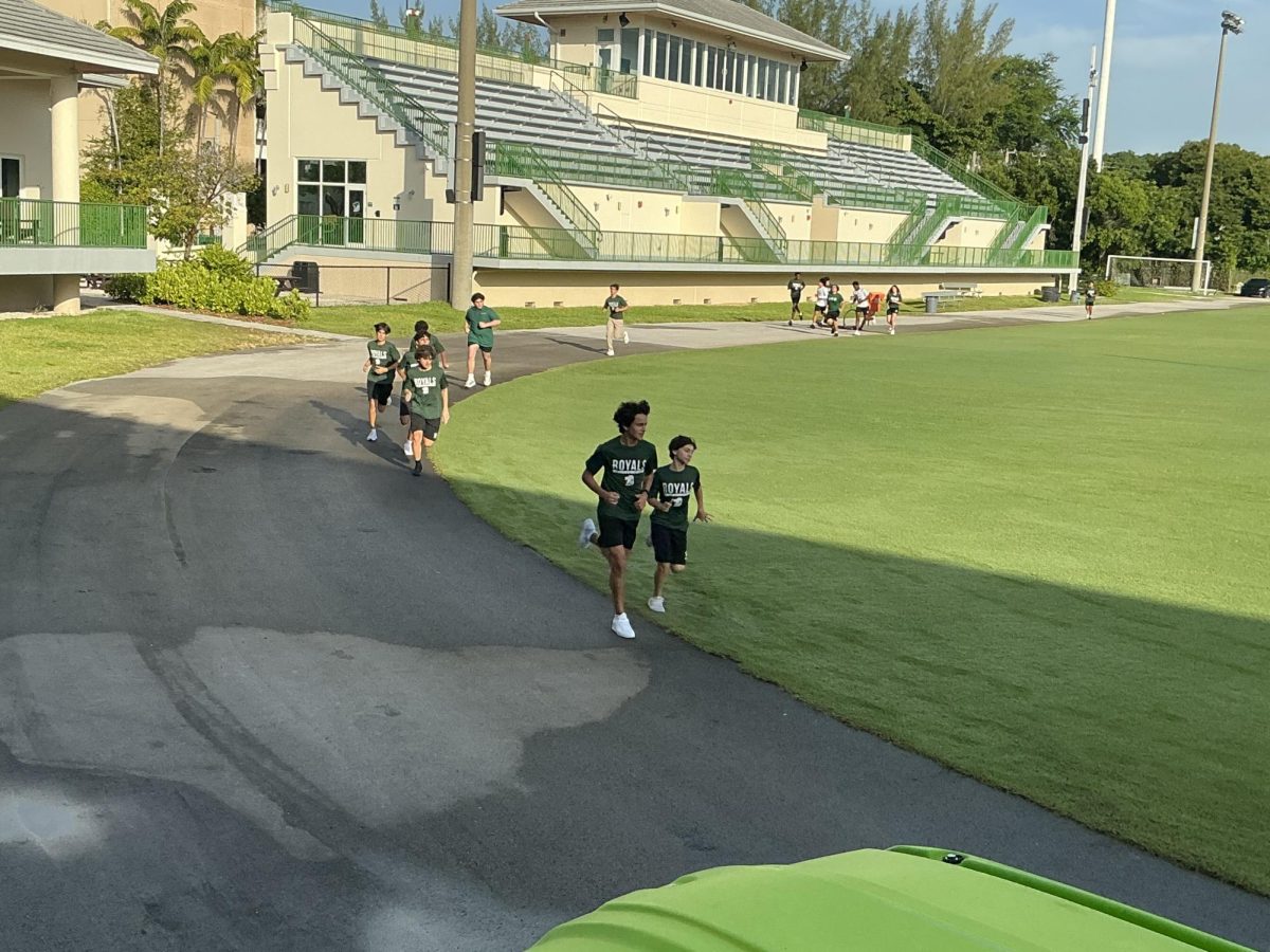 ILS Sophomores running lap around the field with their classmates.