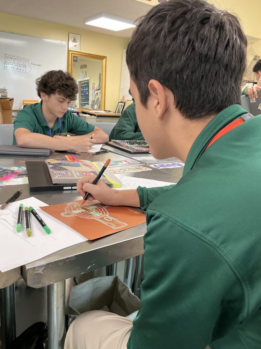 Sophomore Pablo Alonso colors in his crucifix art and designs it in his style.