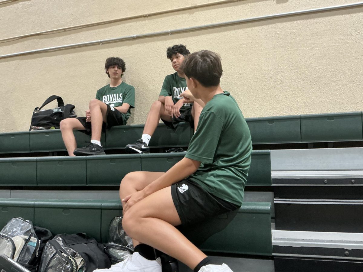 3 students discuss next activity during E block ILS gym class