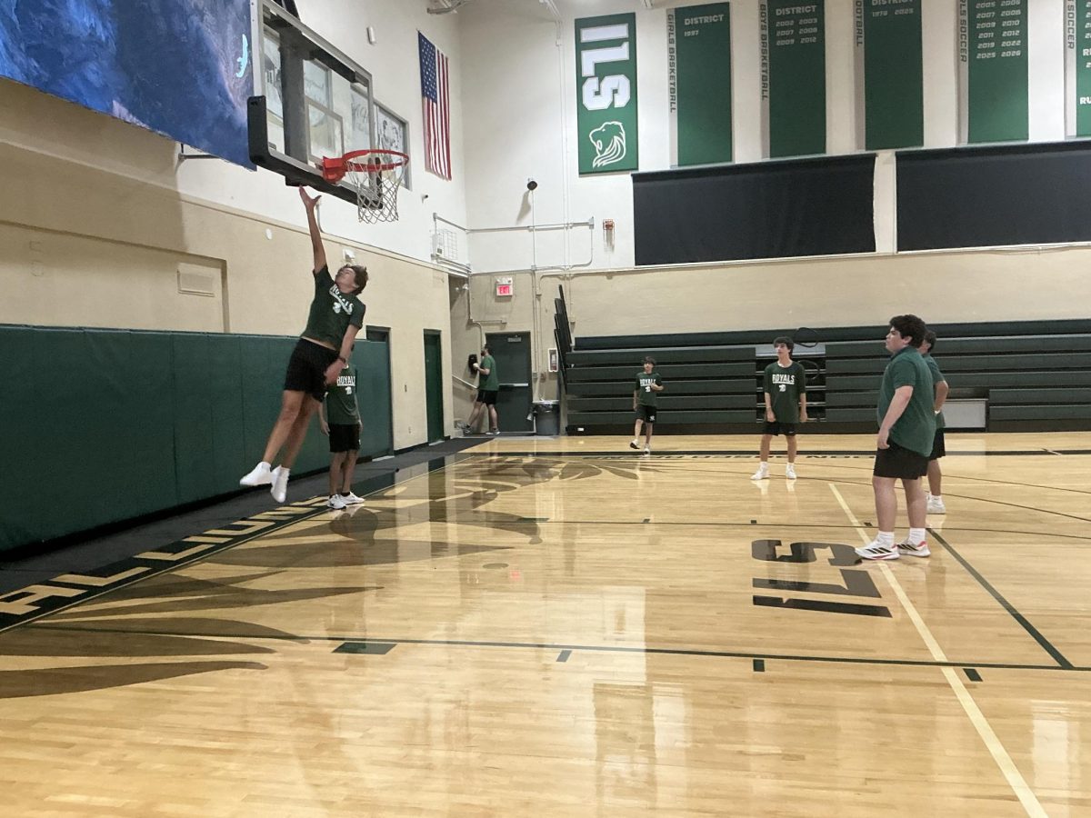 Students In The ILS Gymnasium Trying To Find Out Who Can Touch The Rim