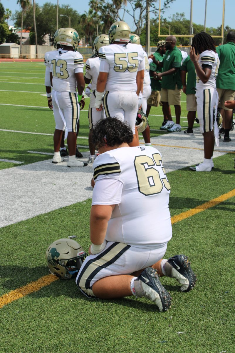 Senior Kevin Matas rests on the field after a long game.