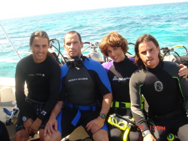 Brothers and sister celebrate having achieved Advanced Open Water SCUBA certification off the coast of Key Largo, Florida.