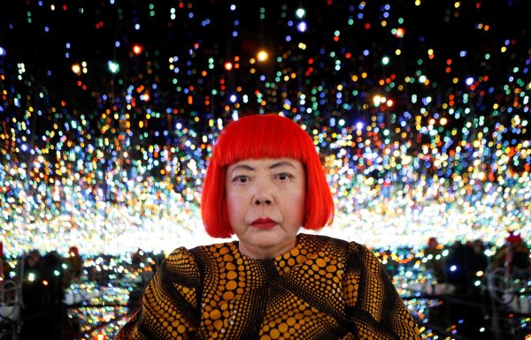 Japanese artist Yayoi Kusama poses for a photograph inside her Infinity Mirrored Room installation titled "The Souls of Millions of Light Years Away" during a media preview of her new exhibition at the David Zwirner gallery in New York November 7, 2013. REUTERS/Mike Segar