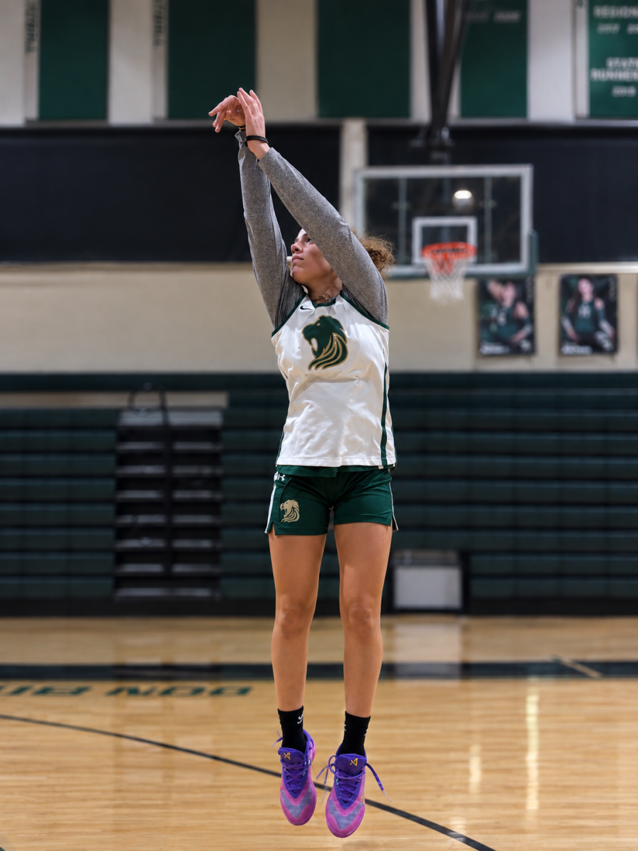 A jump and the flick of the wrist demonstrate how Frida Acevedo perfects her plays in an empty gym hours before scheduled practice time.  