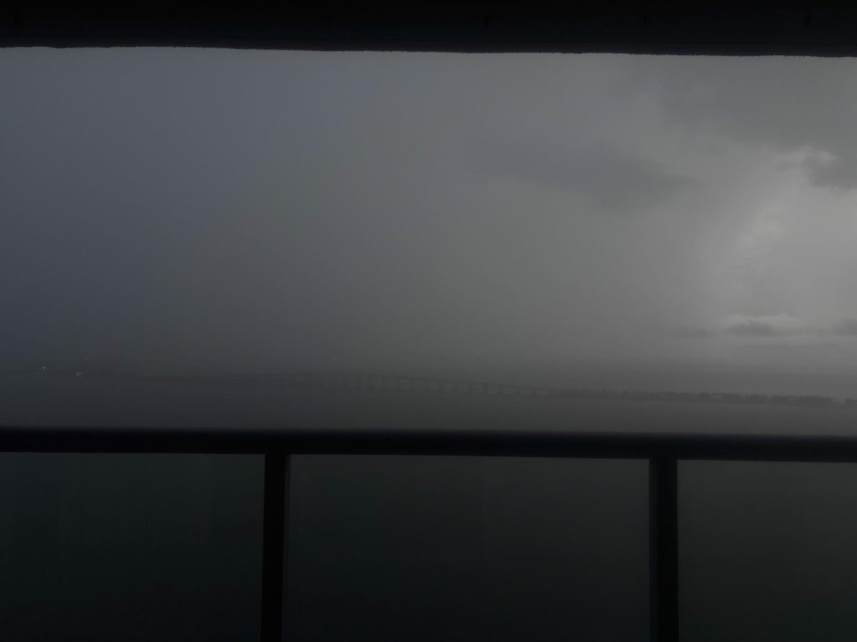 This image captures a storm darkening the sky, rain covering the Key Biscayne bridge. Hurricane season is officially here.
