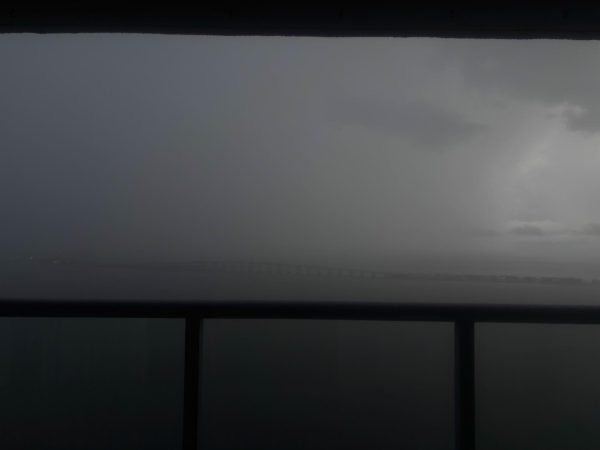 This image captures a storm darkening the sky, rain covering the Key Biscayne bridge. Hurricane season is officially here.