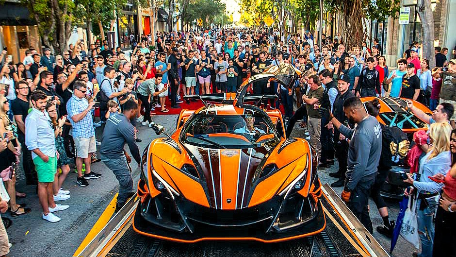 Many people stand around the rare Apollo Intensa Emozione and take pictures.