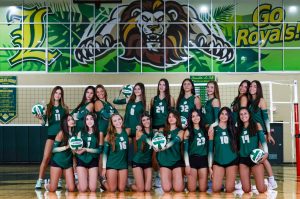 The Varsity Lady Royals Volleyball team pose for a team photo during Media Day.