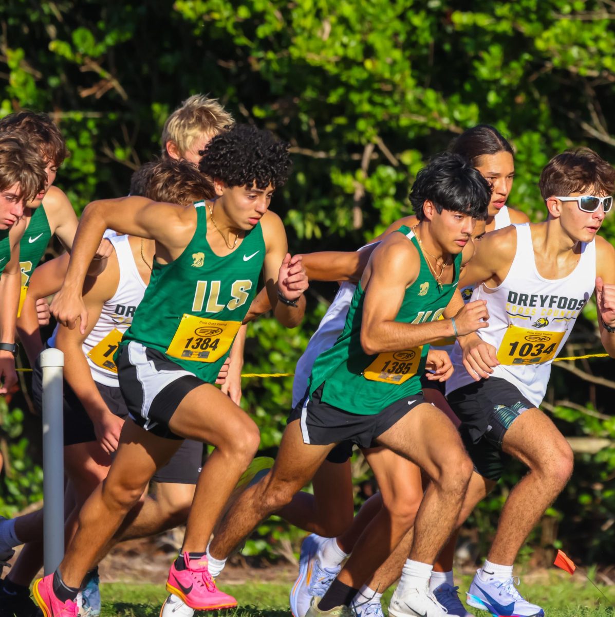 ILS runners Andrew Brito and Daniel Brito race alongside their competitors during the team’s first Cross Country meet of the season. The brothers show their focus and determination as they push through the course and give their best effort.