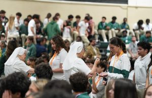 Students receive the Eucharist during an Immaculata-La Salle Mass celebrate their faith as one community of believers.