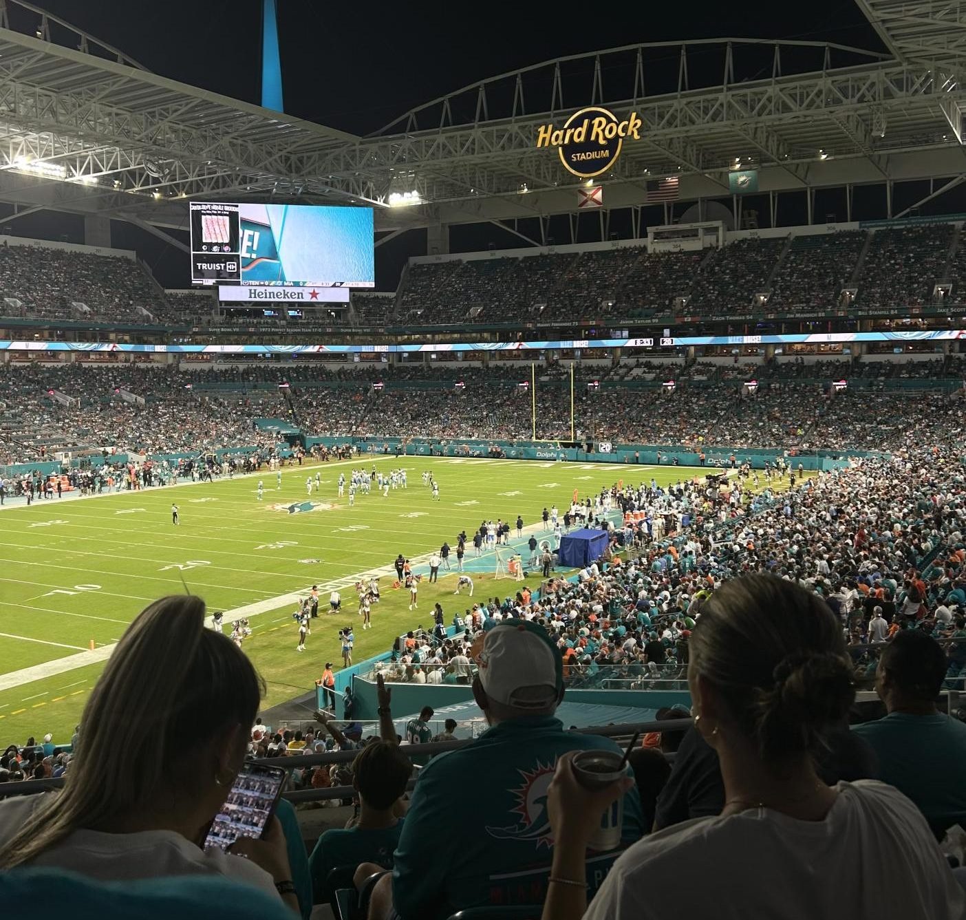 Fans watch the Dolphins compete under the lights at Hard Rock Stadium.