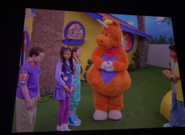 Buddy appears with the children before the colorful television world begins to take a darker turn. 