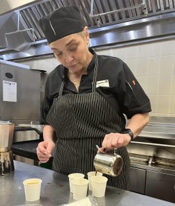 Chef Ibet Dilla enjoys a coffee with her fellow chefs after a school day of serving citrus pork carnitas.