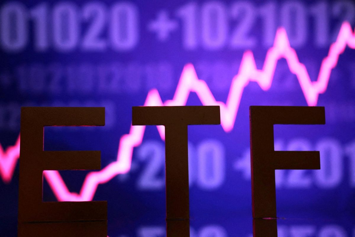 A 3D printed word "ETF (Exchange-Traded Fund)" is seen in front of rising stock graph in this illustration taken October 16, 2025. REUTERS/Dado Ruvic/Illustration